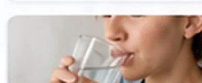 Person tasting a glass of water